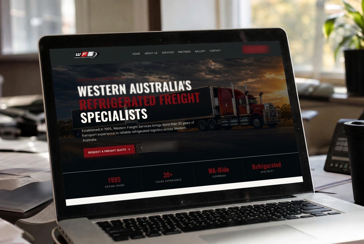 Laptop on an office desk showing the Western Freight Services refrigerated freight website
